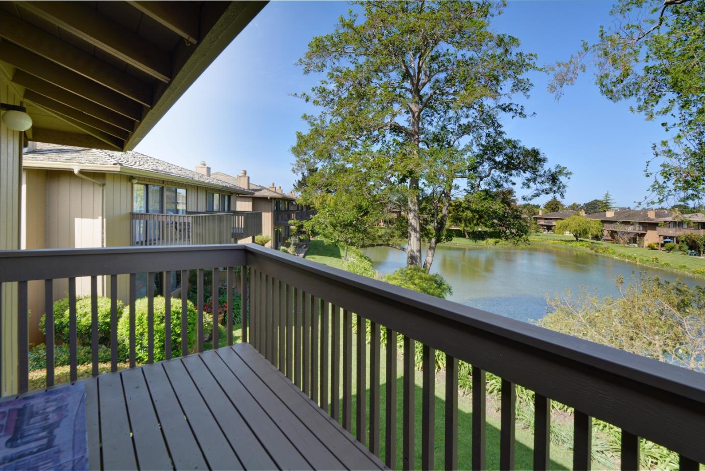 3850 Rio Road, Unit 40 Carmel, CA 93923 - Photo 23 of 28 a balcony with wooden floor and lake view