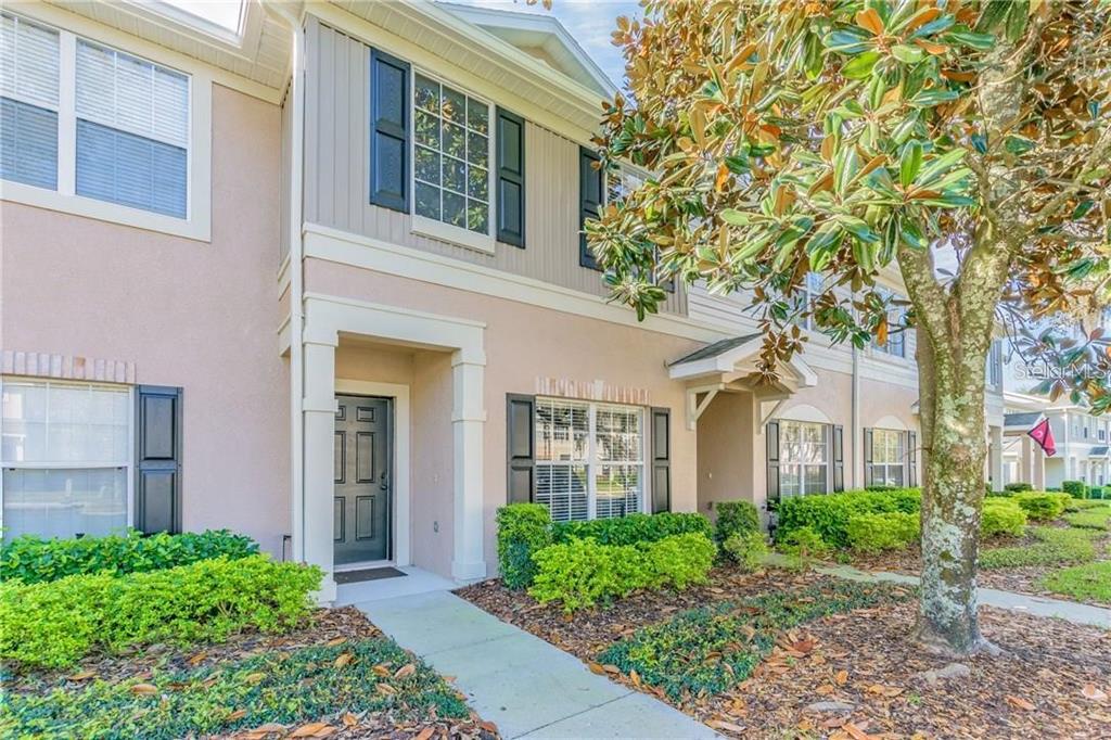 front view of a brick house with a yard