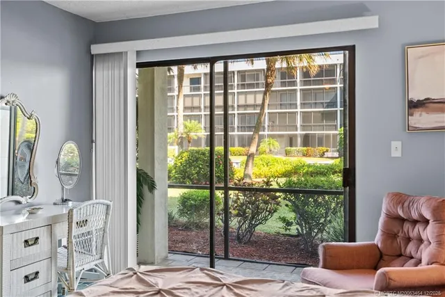 a living room filled with furniture and a large window