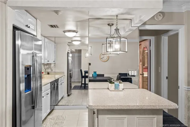a kitchen with stainless steel appliances a refrigerator and a stove