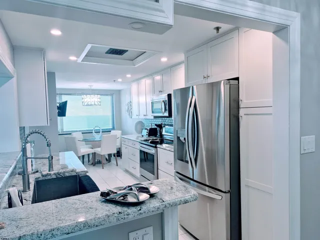 a kitchen with a stove a sink and a refrigerator