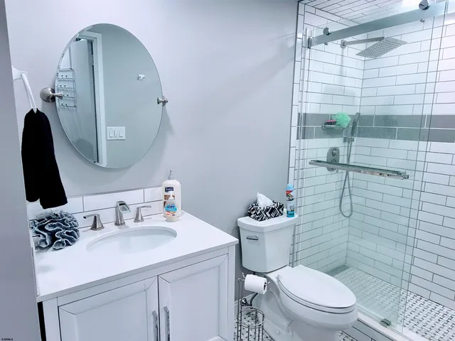 a bathroom with a toilet a sink and shower
