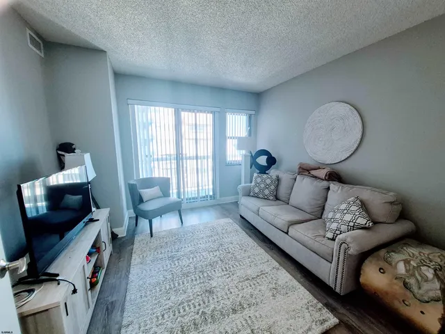 a bedroom with a bed couch and a window