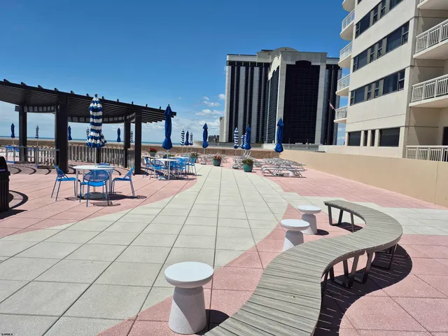 a building outdoor space with patio furniture and potted plants