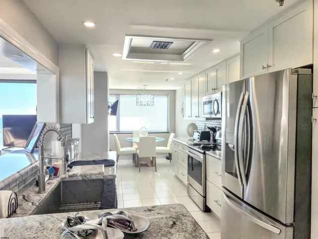 a kitchen with a sink and chairs