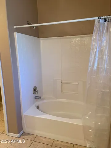 a white bath tub sitting next to a white toilet