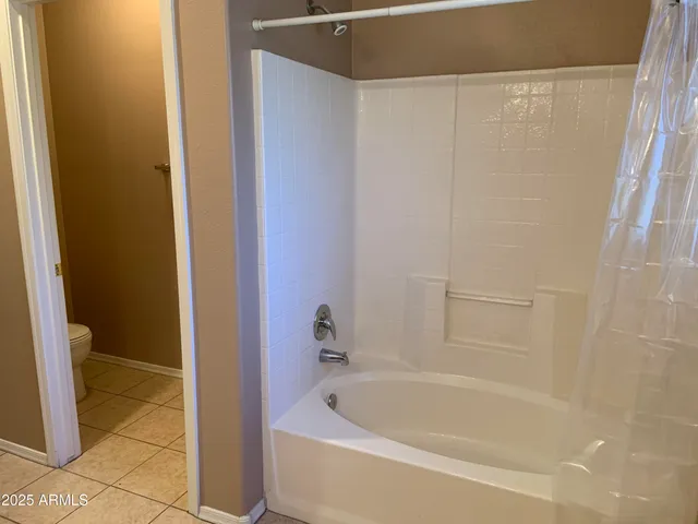 a bathroom with a sink and mirror with toilet
