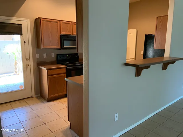 a kitchen with a refrigerator and cabinets