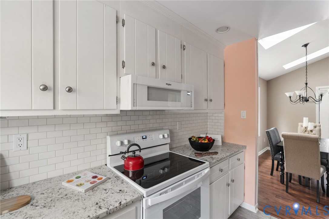 10324 Natural Bridge Road Chesterfield, VA 23236 - Photo 11 of 31 a kitchen with stainless steel appliances granite countertop a sink stove and cabinets