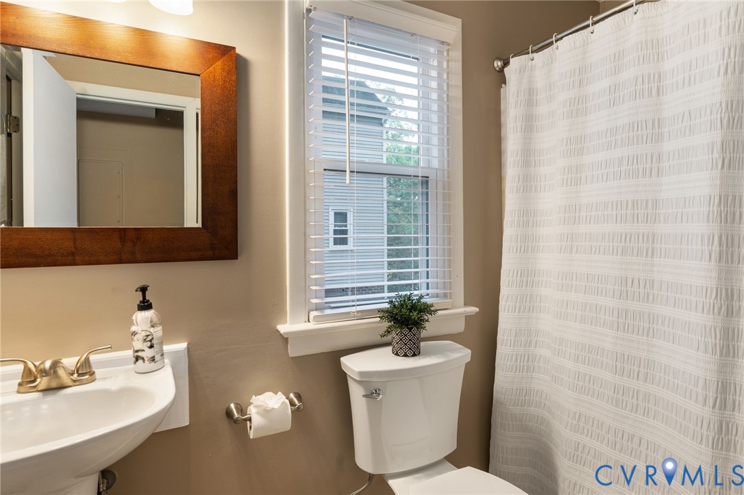 10324 Natural Bridge Road Chesterfield, VA 23236 - Photo 13 of 31 a bathroom with a toilet a sink and a mirror