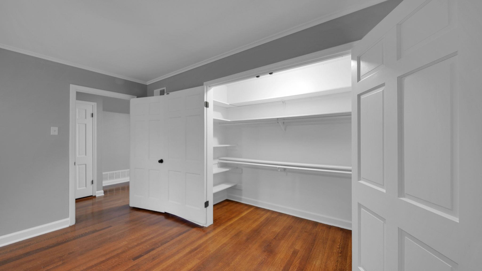 5256 Collingwood Road Memphis, TN 38117 - Photo 32 of 40 Unfurnished bedroom with dark wood finished floors, ornamental molding, and a walk in closet