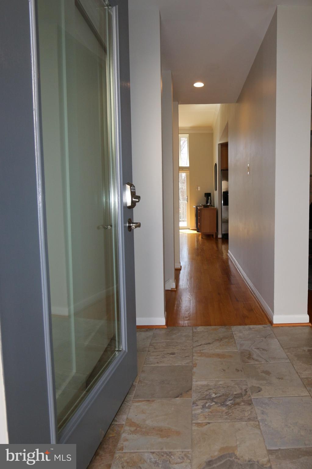 1583 Inlet Court Reston, VA 20190 - Photo 3 of 30 a view of a hallway with wooden floor and a living room