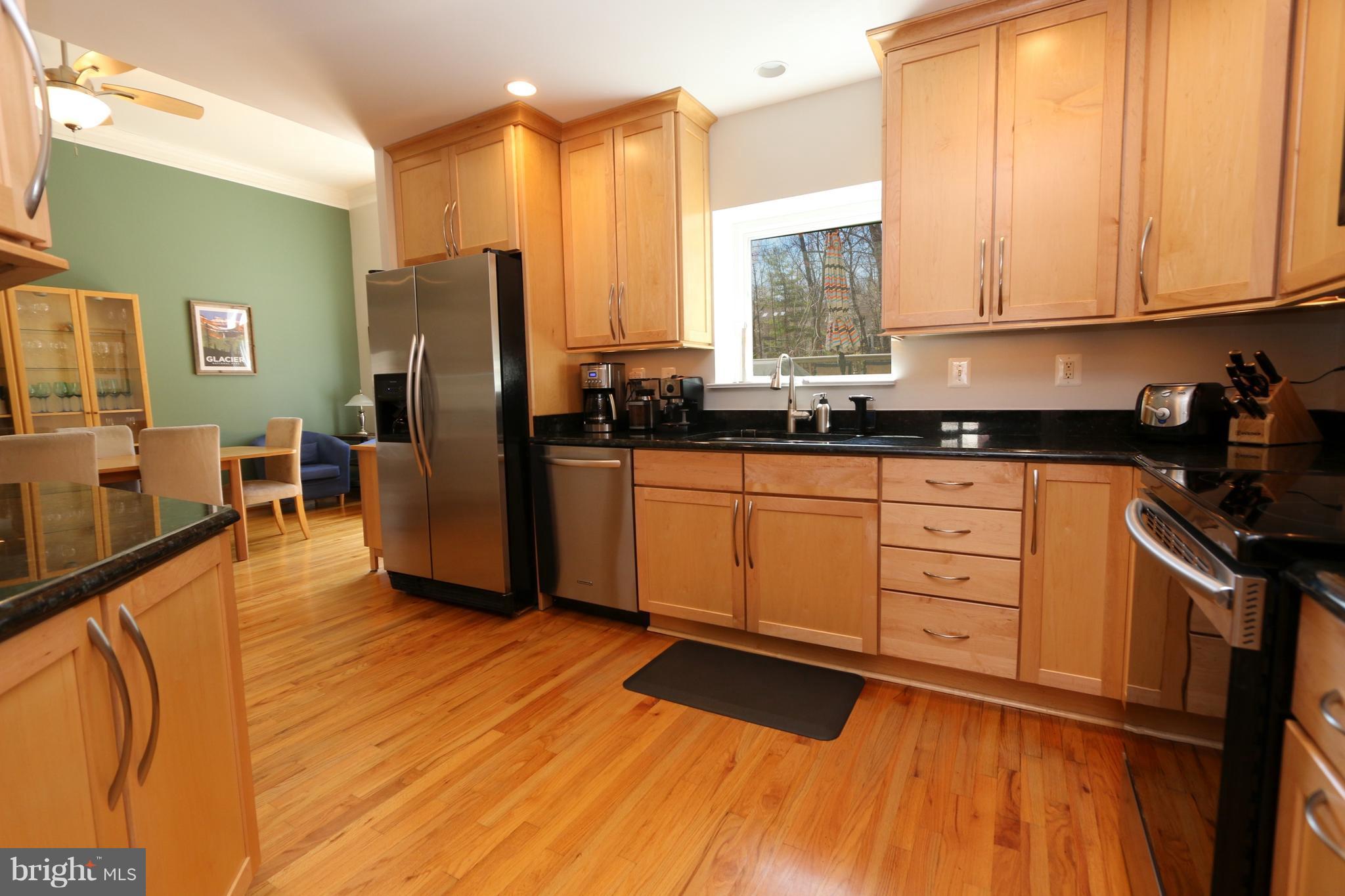1583 Inlet Court Reston, VA 20190 - Photo 7 of 30 a kitchen with stainless steel appliances granite countertop a stove a sink and a refrigerator