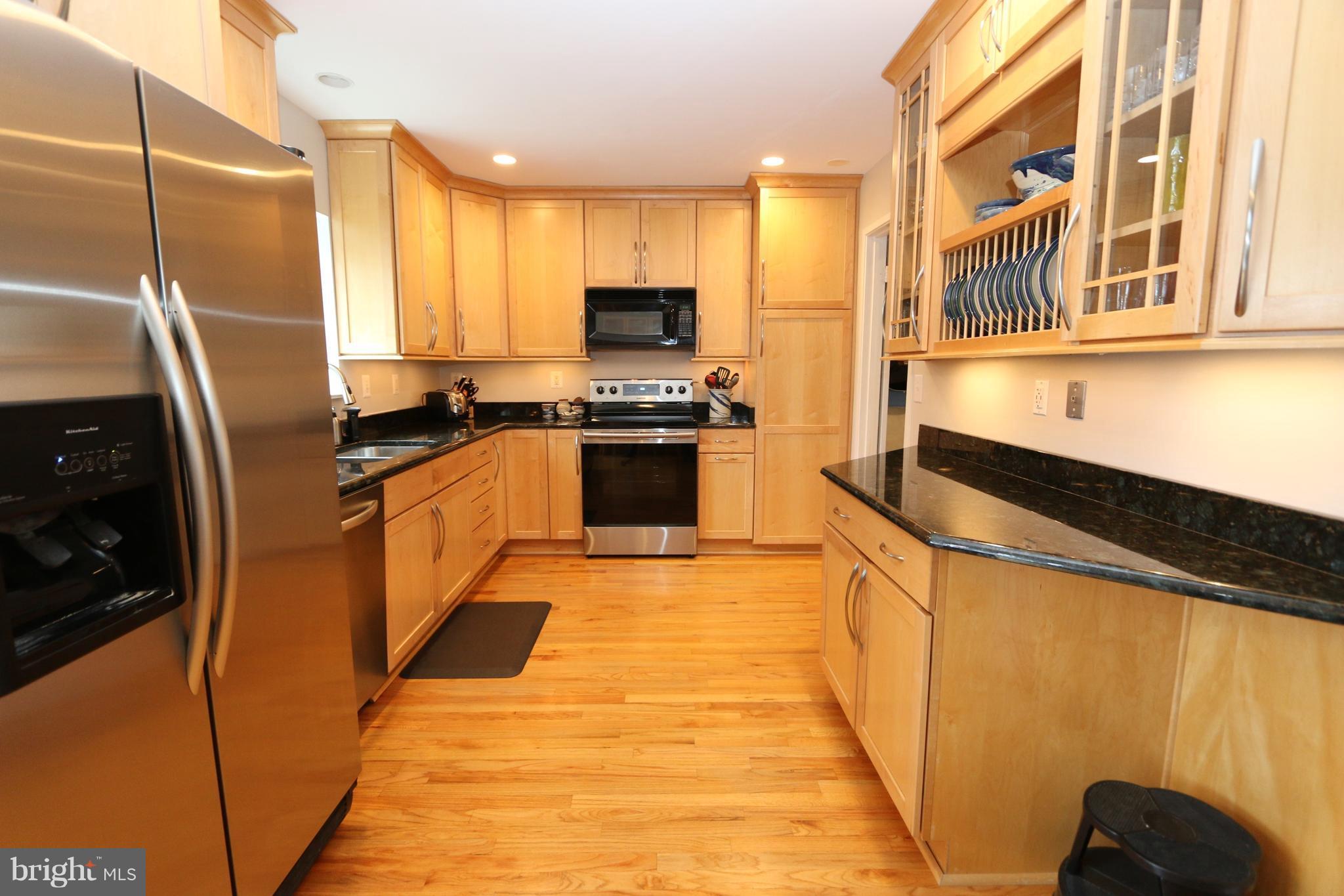 1583 Inlet Court Reston, VA 20190 - Photo 8 of 30 a kitchen with stainless steel appliances granite countertop a stove a refrigerator and a sink