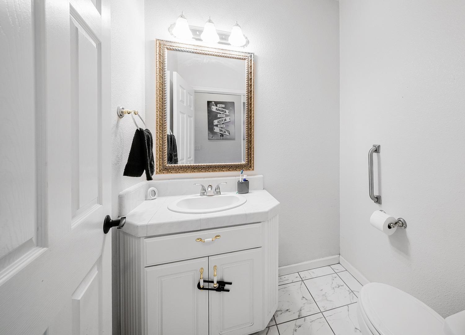 19360 Maple Street Laton, CA 93242 - Photo 12 of 53 a bathroom with a sink a toilet and mirror