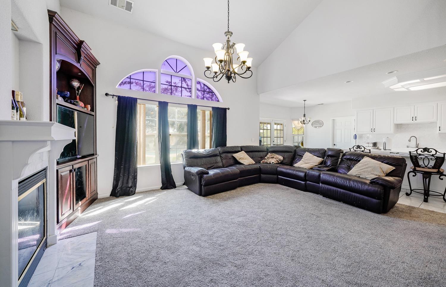 19360 Maple Street Laton, CA 93242 - Photo 14 of 53 a living room with furniture a chandelier and a fireplace