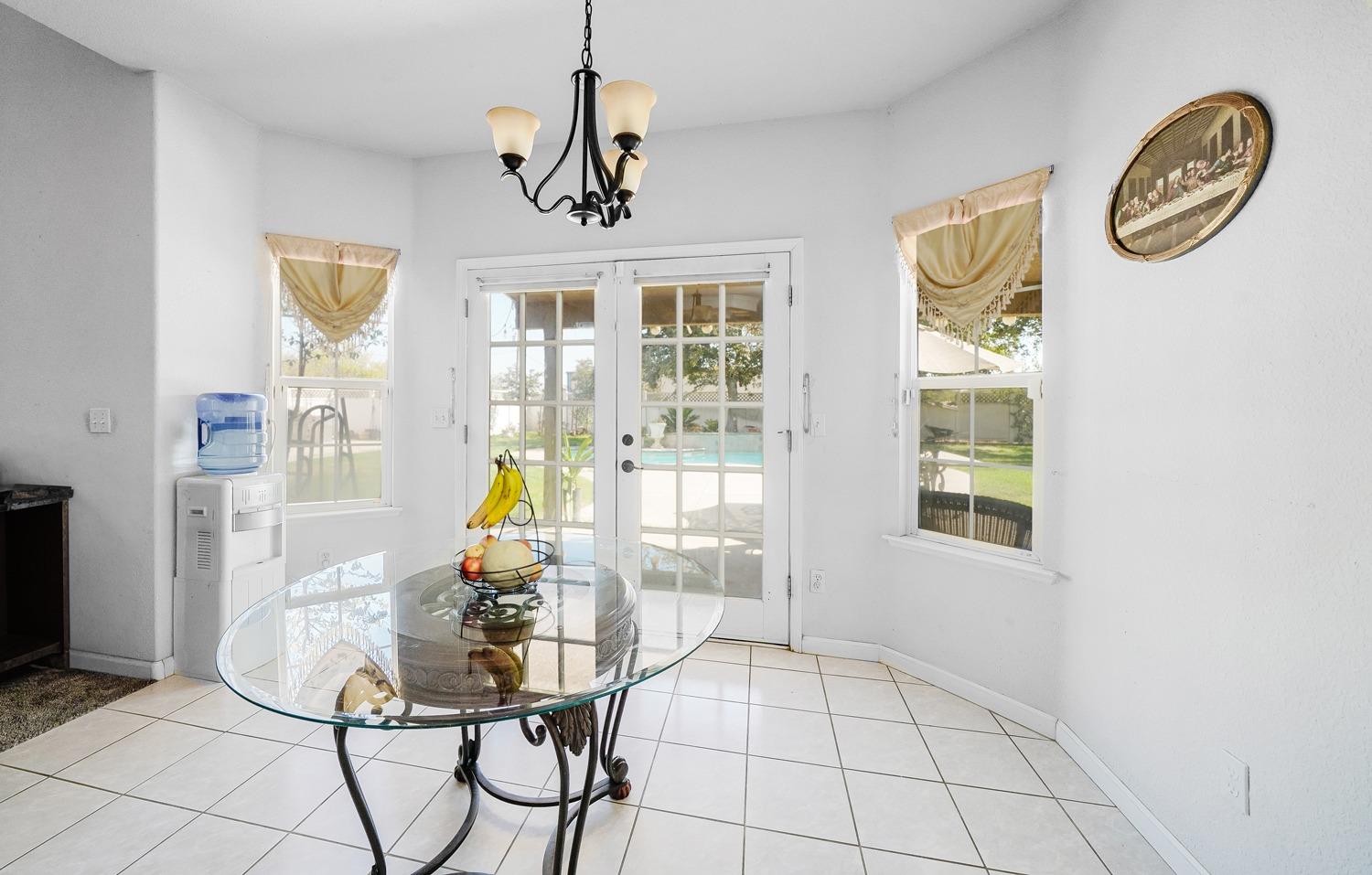 19360 Maple Street Laton, CA 93242 - Photo 16 of 53 a view of a dining room with furniture a chandelier and wooden floor