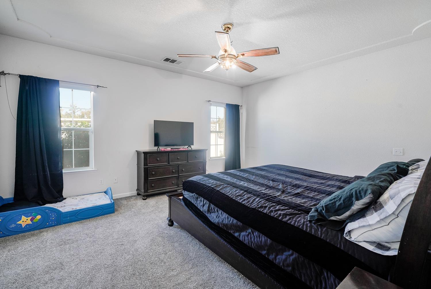 19360 Maple Street Laton, CA 93242 - Photo 21 of 53 a bed room with a bed and a tv