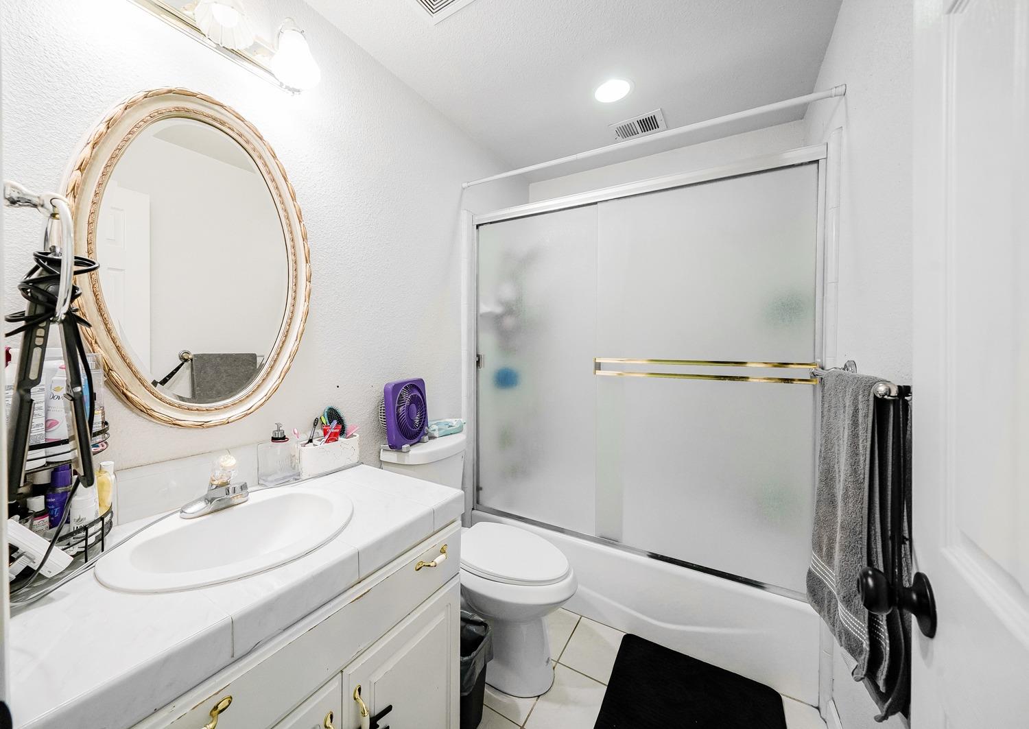 19360 Maple Street Laton, CA 93242 - Photo 28 of 53 a bathroom with a sink toilet and a mirror