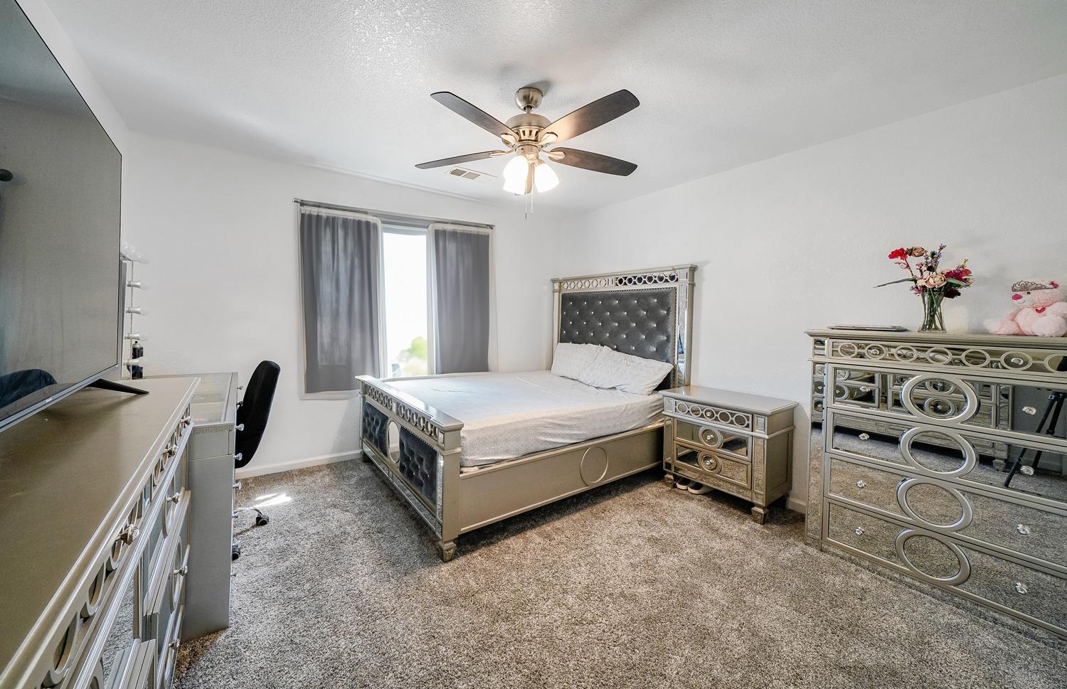 19360 Maple Street Laton, CA 93242 - Photo 29 of 53 a bedroom with a bed and a chandelier