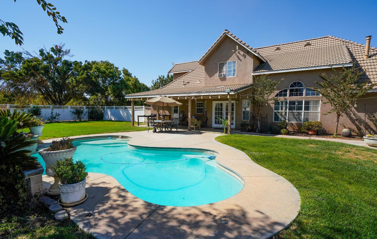 19360 Maple Street Laton, CA 93242 - Photo 36 of 53 a view of a house with swimming pool and a yard