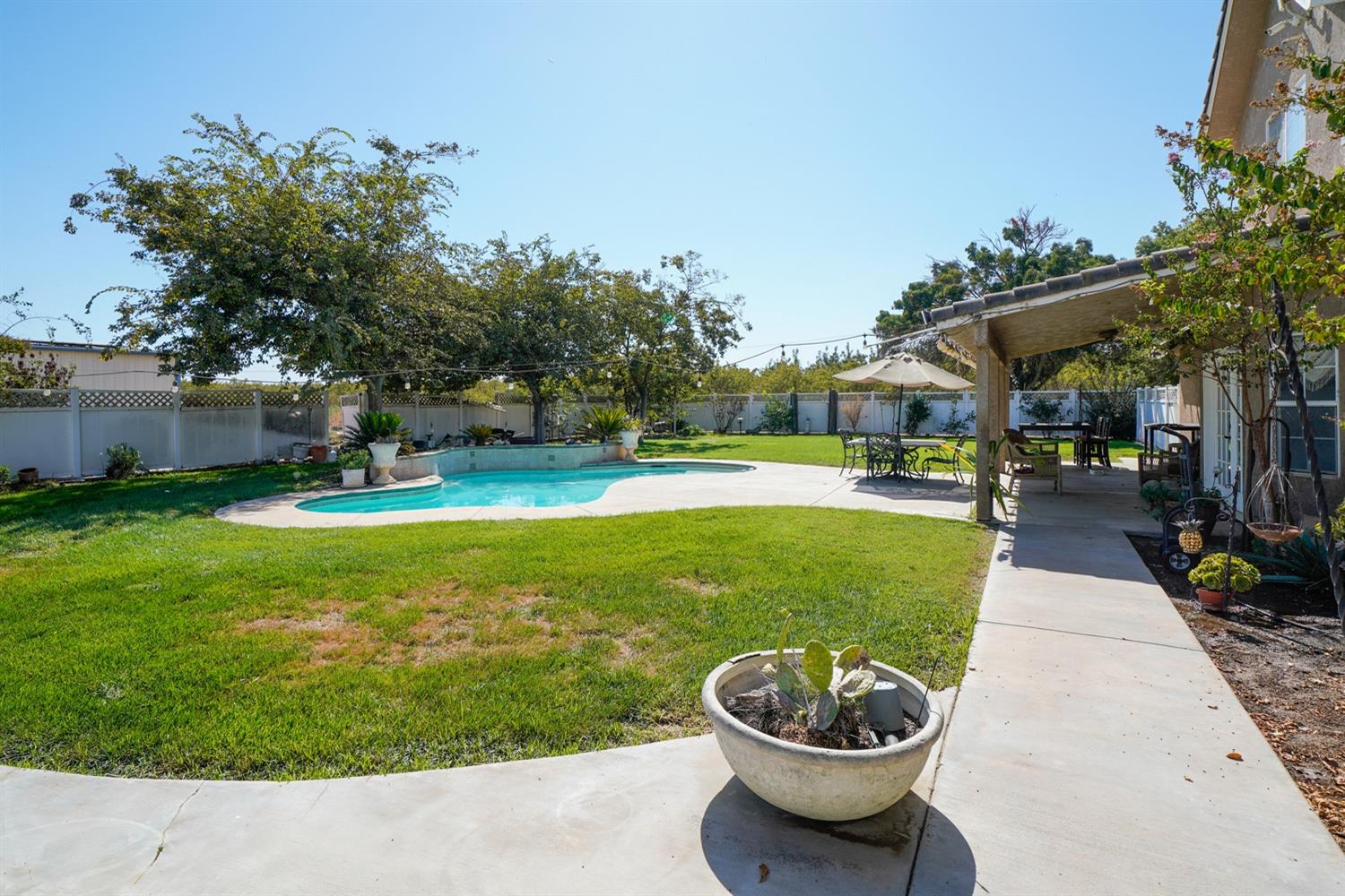 19360 Maple Street Laton, CA 93242 - Photo 39 of 53 a view of a swimming pool with a patio