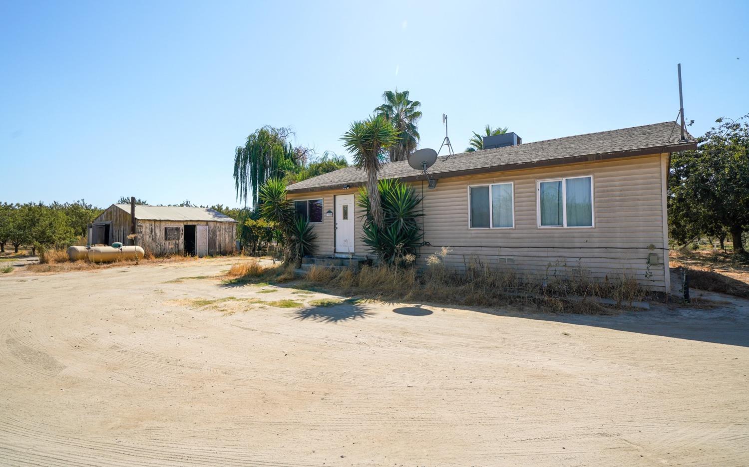19360 Maple Street Laton, CA 93242 - Photo 42 of 53 a front view of a house with a yard and garage