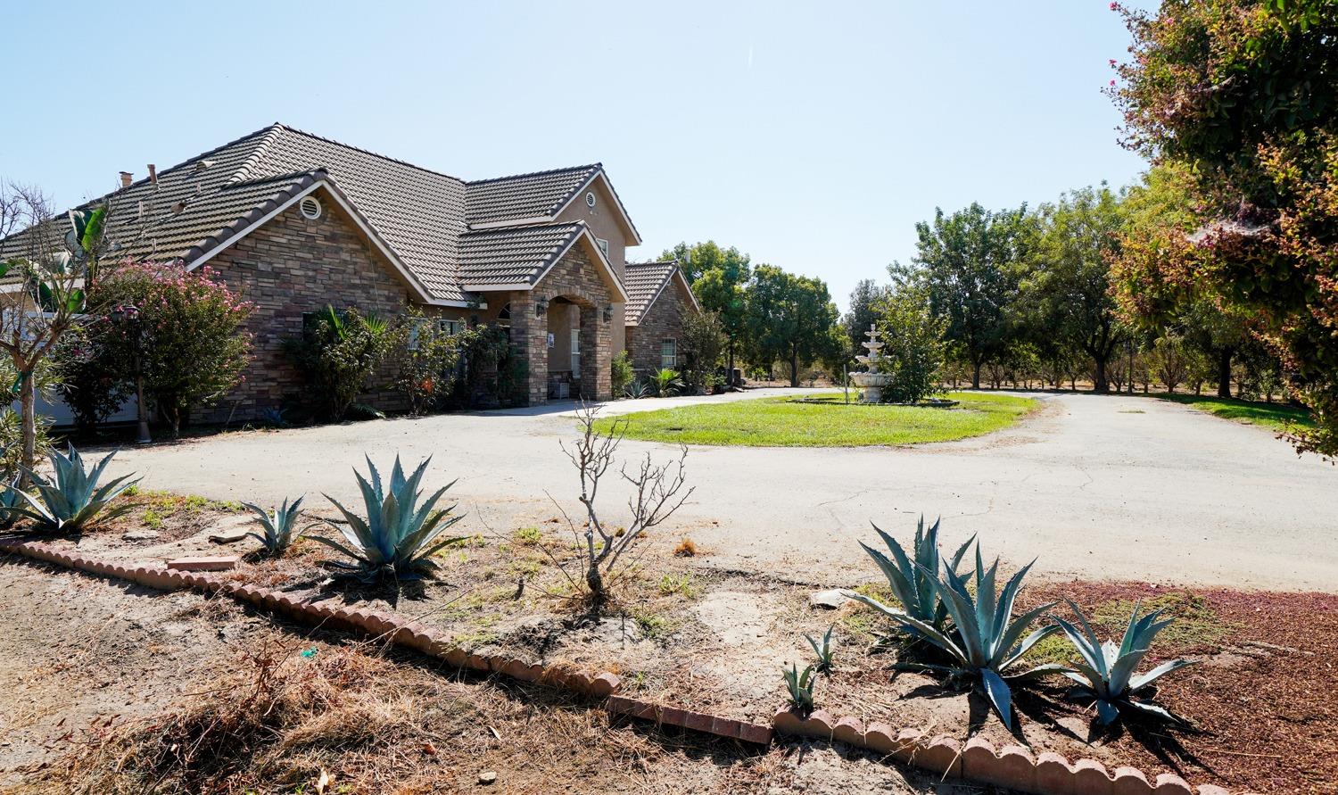 19360 Maple Street Laton, CA 93242 - Photo 45 of 53 a view of a house with a yard and palm trees