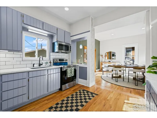 a kitchen with granite countertop wooden cabinets a refrigerator and a sink