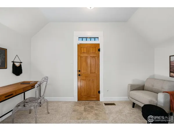 a view of a balcony with wooden floor and fence