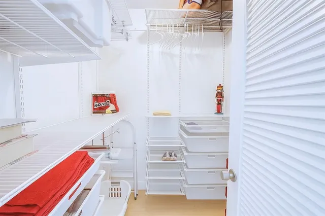 a living room with furniture wooden floor and a large window