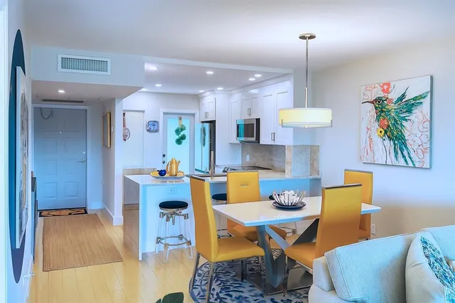 a bathroom with a sink vanity mirror and toilet