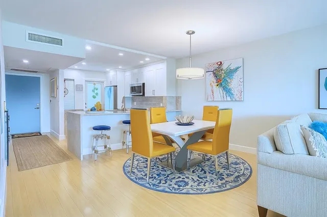 a kitchen with stainless steel appliances granite countertop a sink and a refrigerator