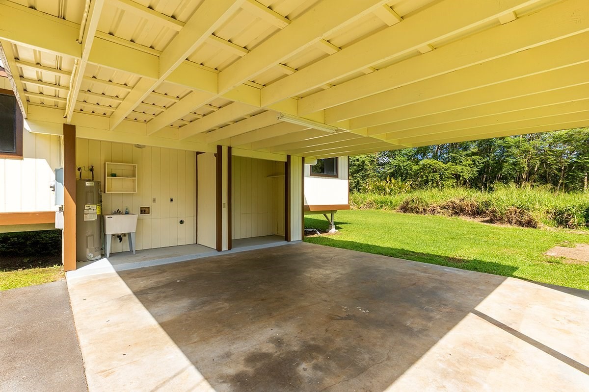 17-4018 Kuaaina Road, Unit 105 Kurtistown, HI 96749 - Photo 12 of 22 a view of a patio with table and chairs and potted plants