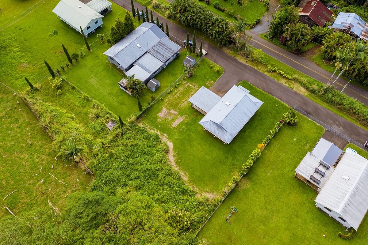 17-4018 Kuaaina Road, Unit 105 Kurtistown, HI 96749 - Photo 19 of 22 an aerial view of a house with a garden and swimming pool