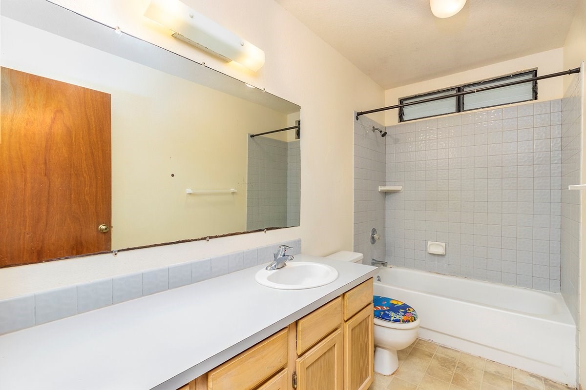 17-4018 Kuaaina Road, Unit 105 Kurtistown, HI 96749 - Photo 5 of 22 a bathroom with a sink a toilet and shower