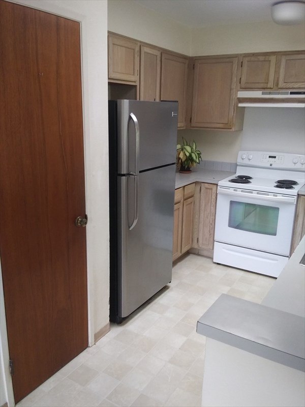 17-4018 Kuaaina Road, Unit 105 Kurtistown, HI 96749 - Photo 6 of 22 a kitchen with a refrigerator sink and stove