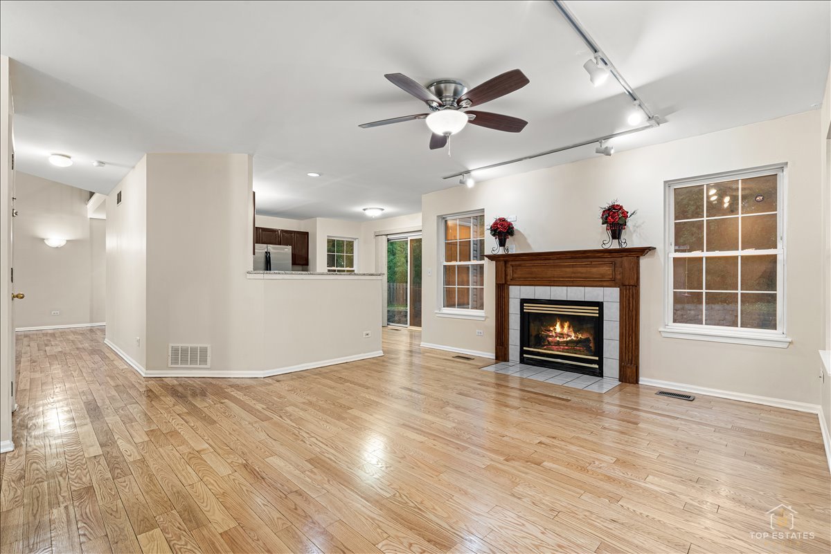 7 Eagle Court Streamwood, IL 60107 - Photo 12 of 31 a view of livingroom with fireplace wooden floor and window