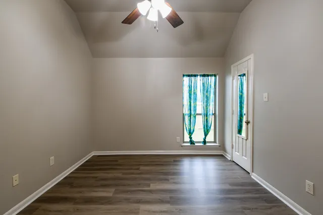 wooden floor in an empty room with a window