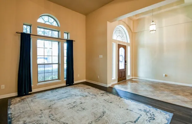 a view of a hallway with wooden door