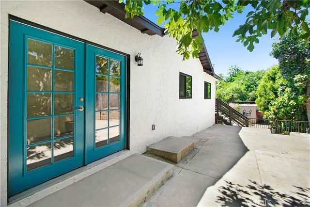 a balcony with potted plants and wooden fence
