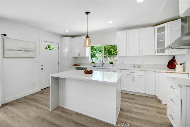 a kitchen with a sink a refrigerator and window