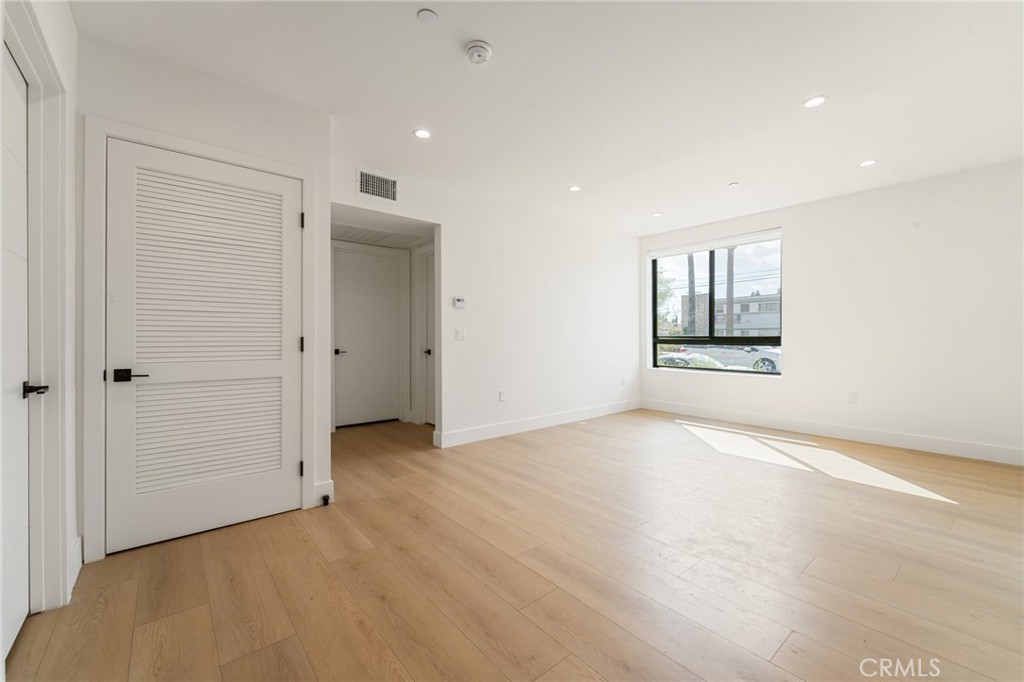 7510 Sepulveda Boulevard, Unit 101 Van Nuys, CA 91405 - Photo 12 of 16 an empty room with windows and closet