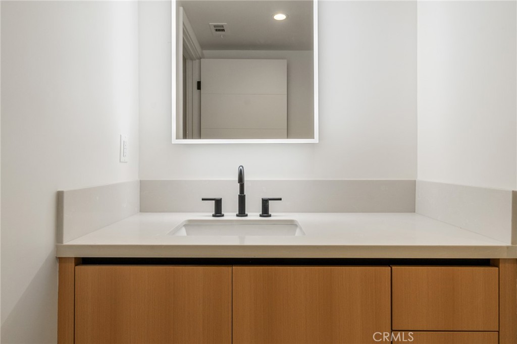 7510 Sepulveda Boulevard, Unit 101 Van Nuys, CA 91405 - Photo 15 of 16 a bathroom with a bathtub and a sink