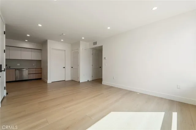 an empty room with an entrance to other room