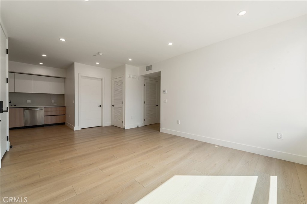 7510 Sepulveda Boulevard, Unit 101 Van Nuys, CA 91405 - Photo 8 of 16 an empty room with an entrance to other room