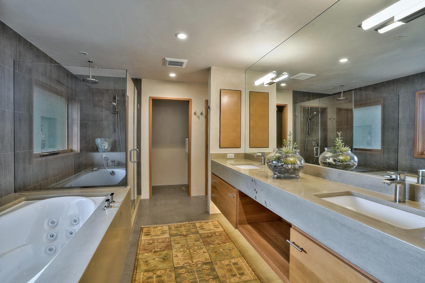 24651 Cabrillo Street Carmel, CA 93923 - Photo 18 of 42 a bathroom with a tub sink and mirror