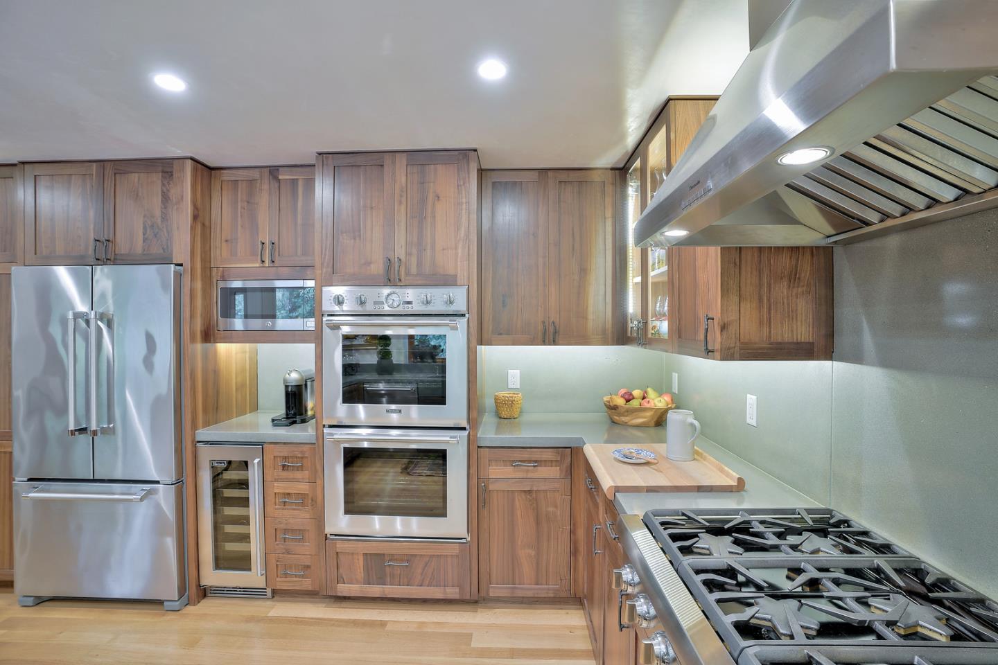 24651 Cabrillo Street Carmel, CA 93923 - Photo 2 of 42 a kitchen with kitchen island a stove and a refrigerator