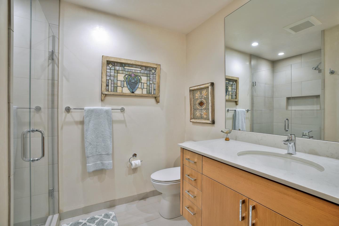 24651 Cabrillo Street Carmel, CA 93923 - Photo 25 of 42 a bathroom with a granite countertop sink toilet and shower