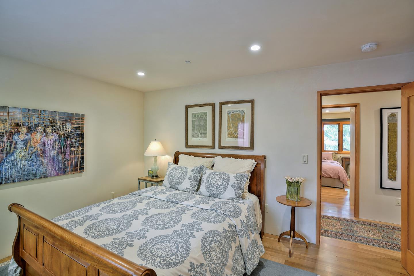 24651 Cabrillo Street Carmel, CA 93923 - Photo 26 of 42 a bedroom with a bed and wooden floor